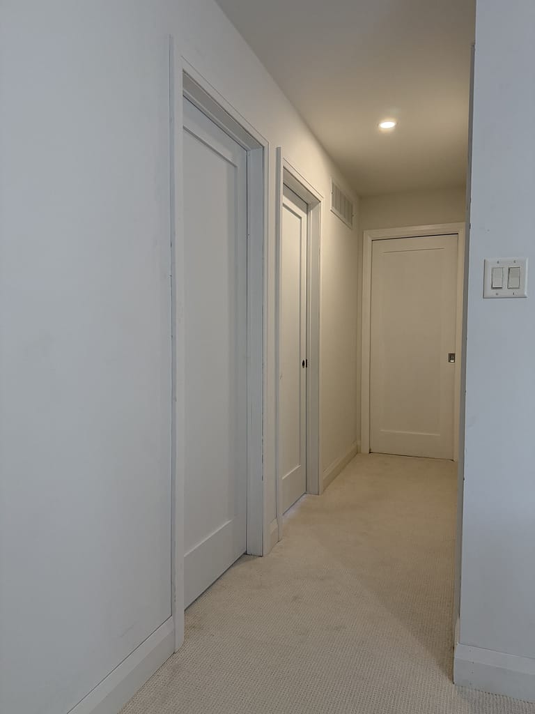 Modern bevel step casing neatly installed around a window in Oakville by finish carpenter Jack Ozer.