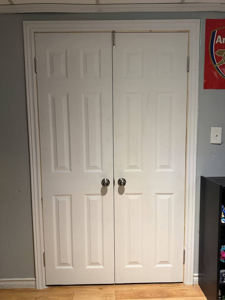 View from inside the room showing the flush margins and clean mitered casing around Luis's new double passage door.
