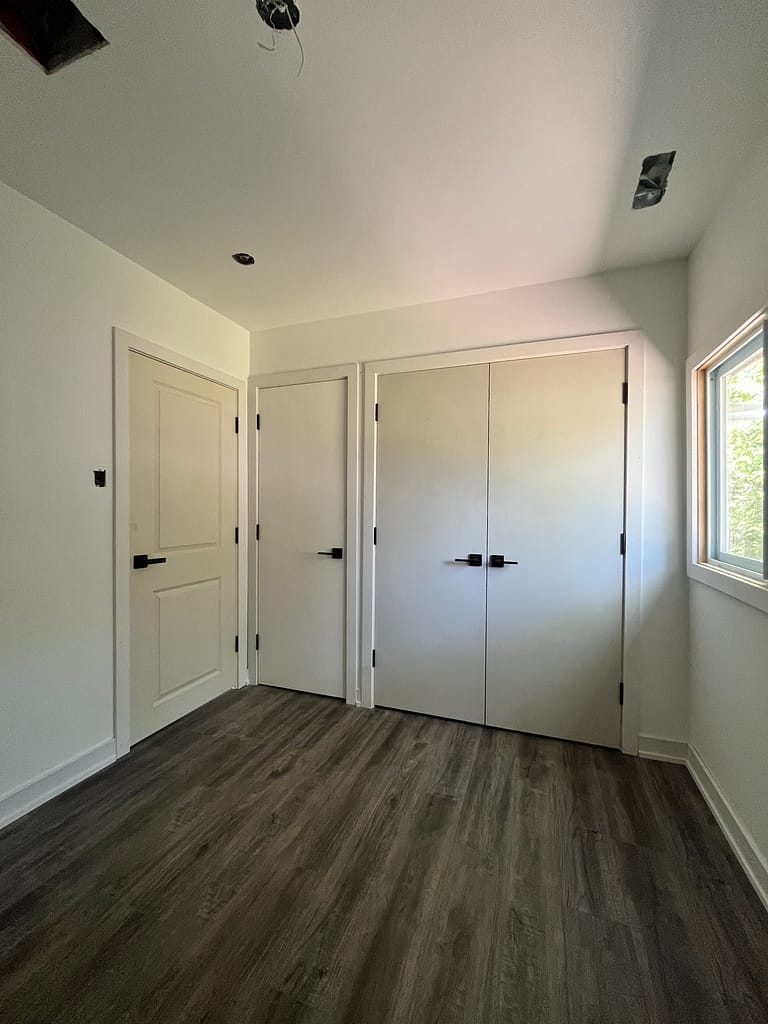 Interior door, double closet doors, casing and baseboards installed in a Milton home.