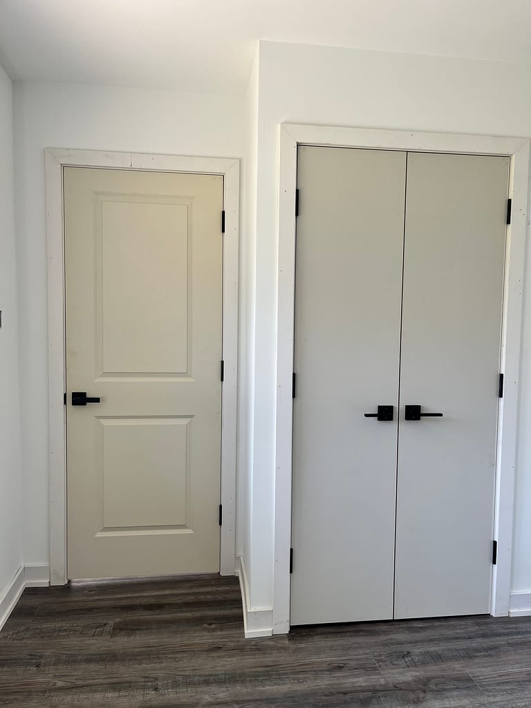 Bedroom interior doors, closet doors, trim and baseboards installed by Wood Job Finish Carpentry in Milton.