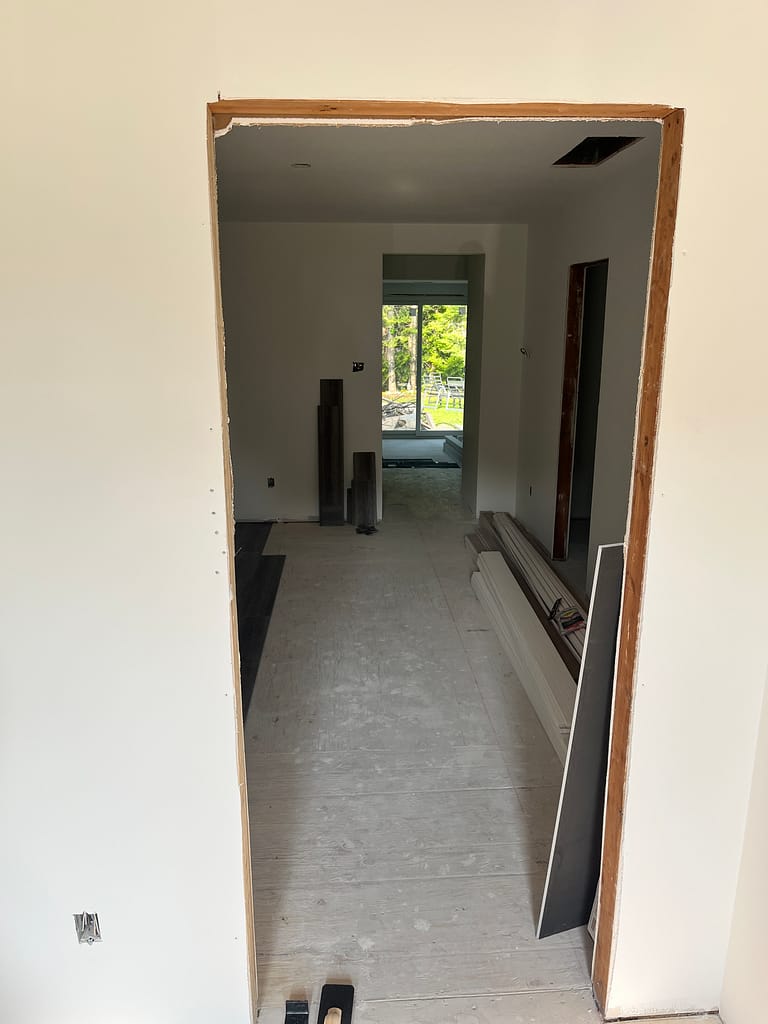 Rough interior doorway opening before trim and casing installation in a Milton renovation project.