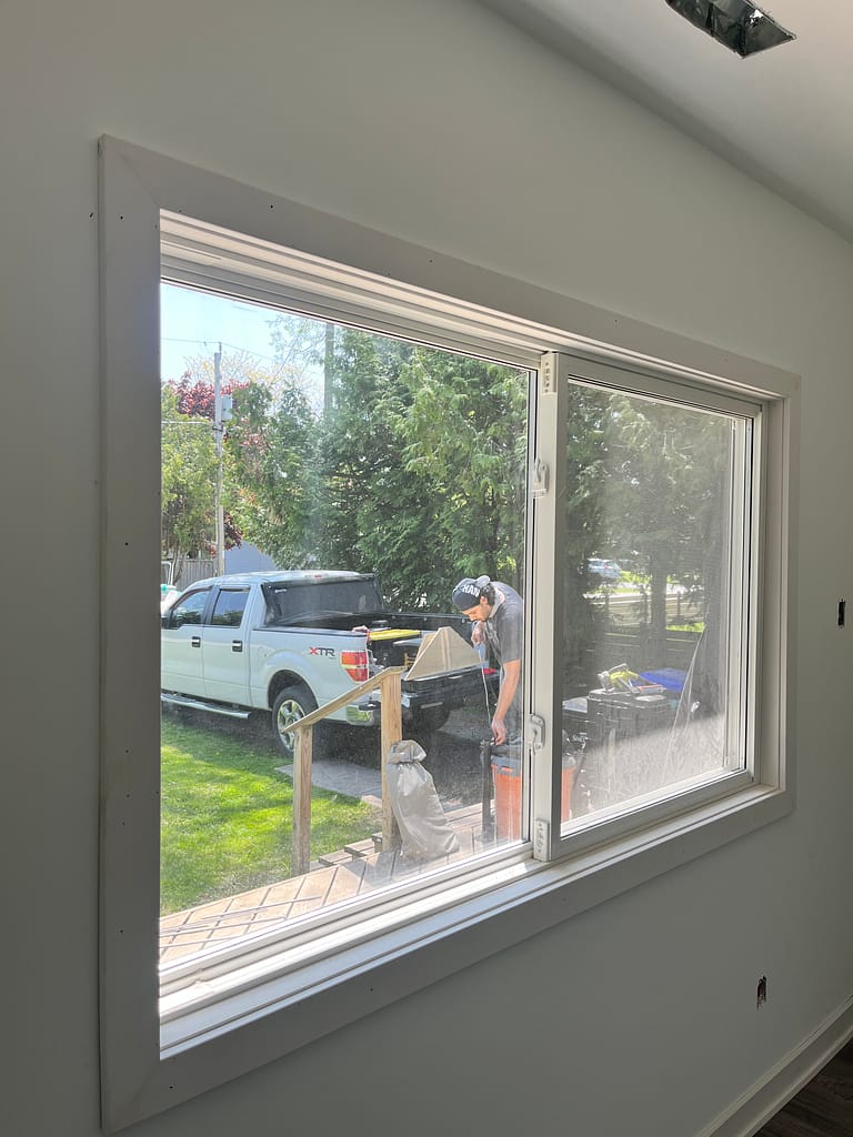 Large window casing and trim installation completed during a Milton renovation project.