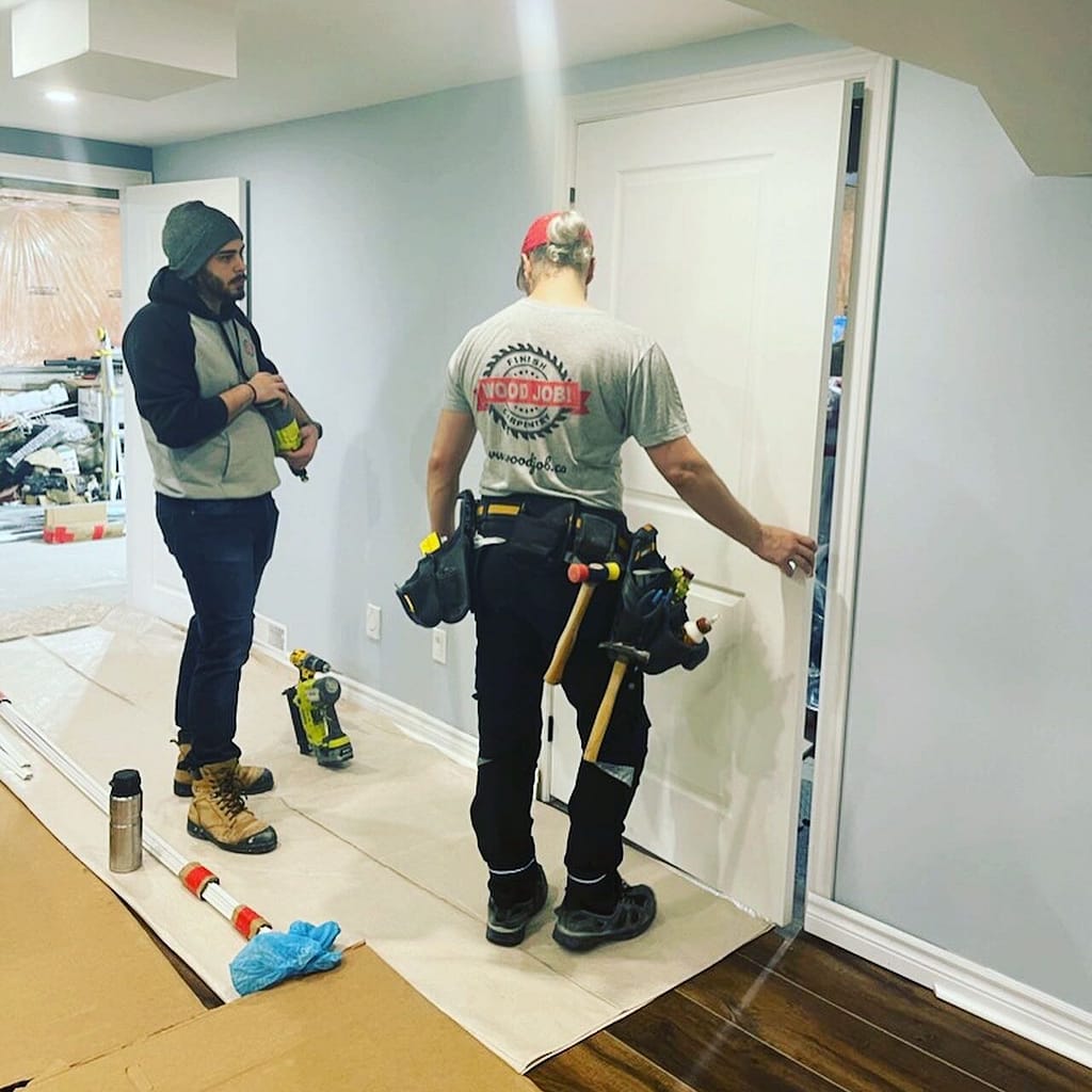 Finish carpenter installing an interior door