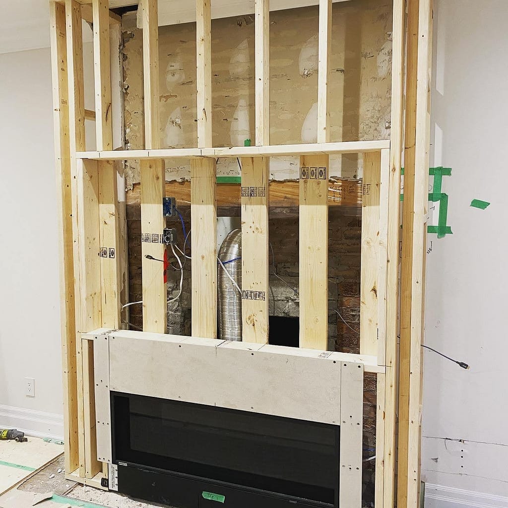 Framing stage for a fireplace feature wall in Milton