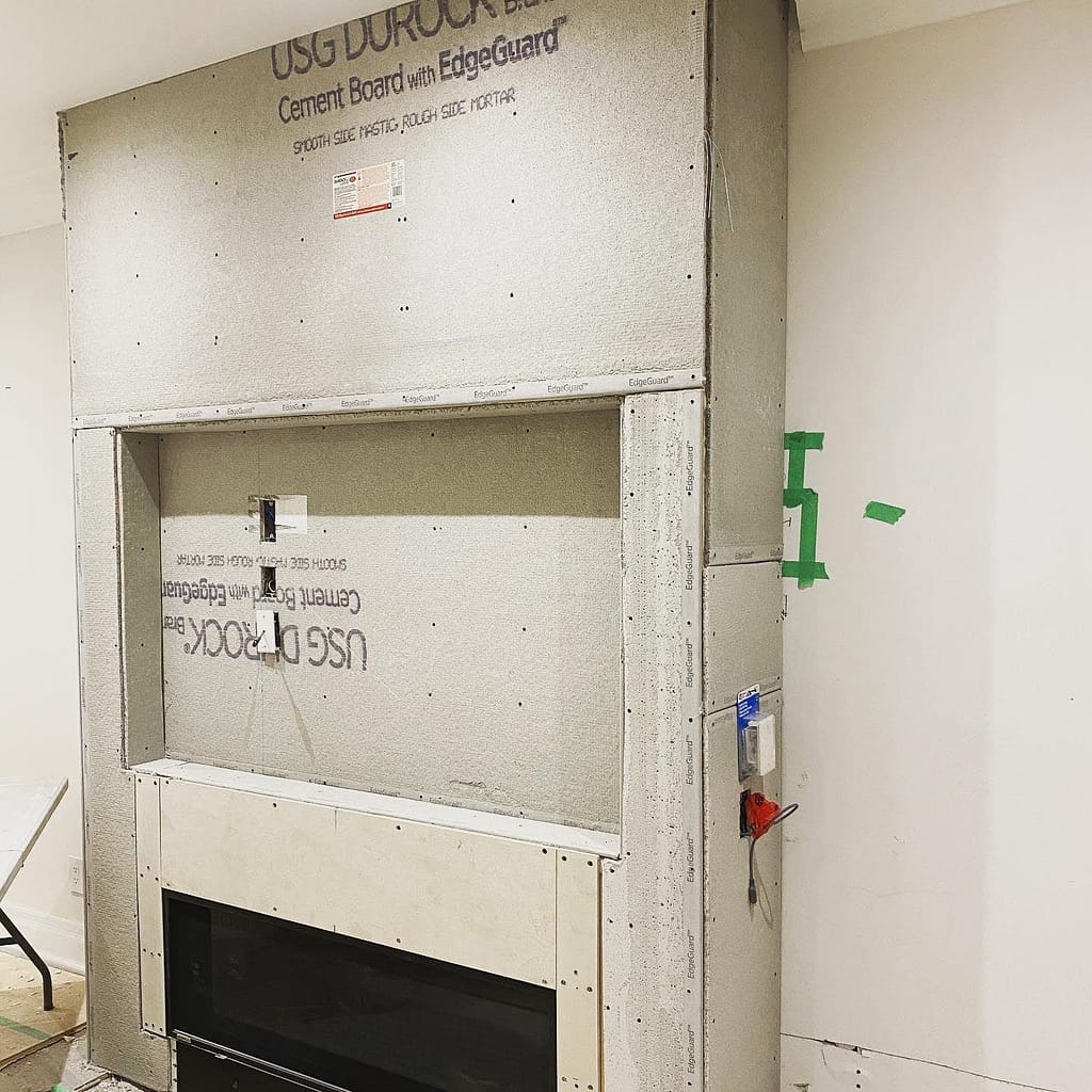 Cement board installed over the fireplace feature wall frame in Milton