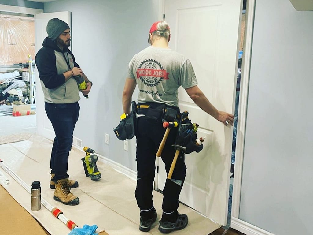 finish carpenter Jack Cenk Ozer installing a pre-hung door in Toronto home