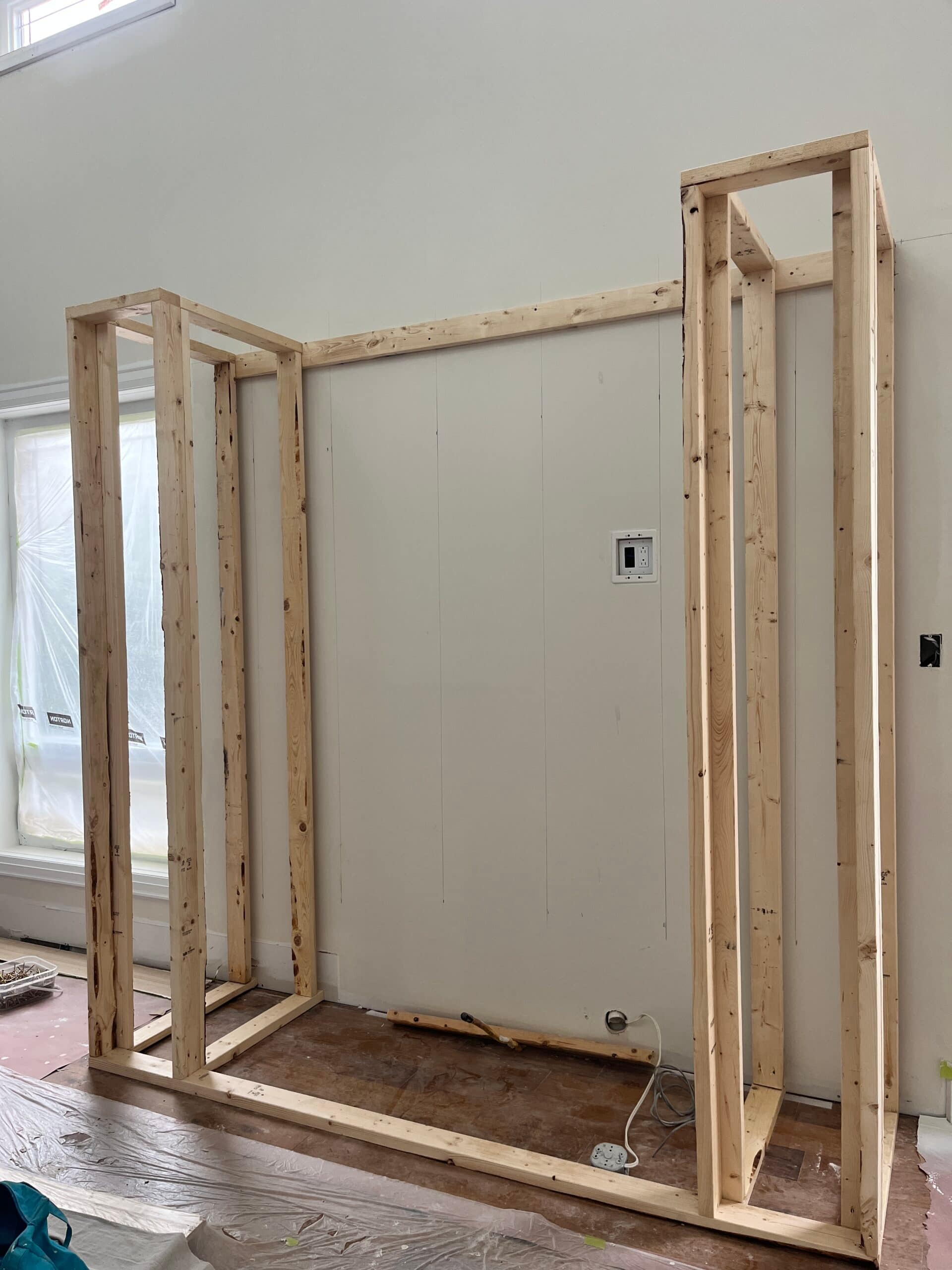 Framing in progress for a black tile fireplace feature wall in Oakville