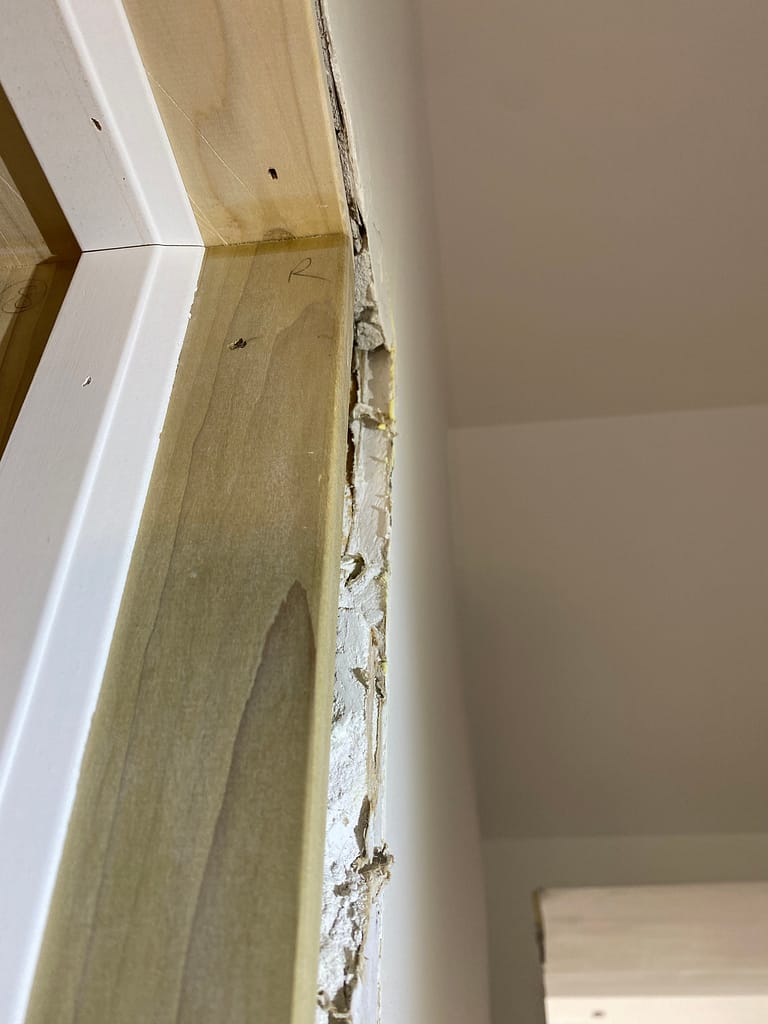 A hump on a drywall needs fix around the door opening before the installation