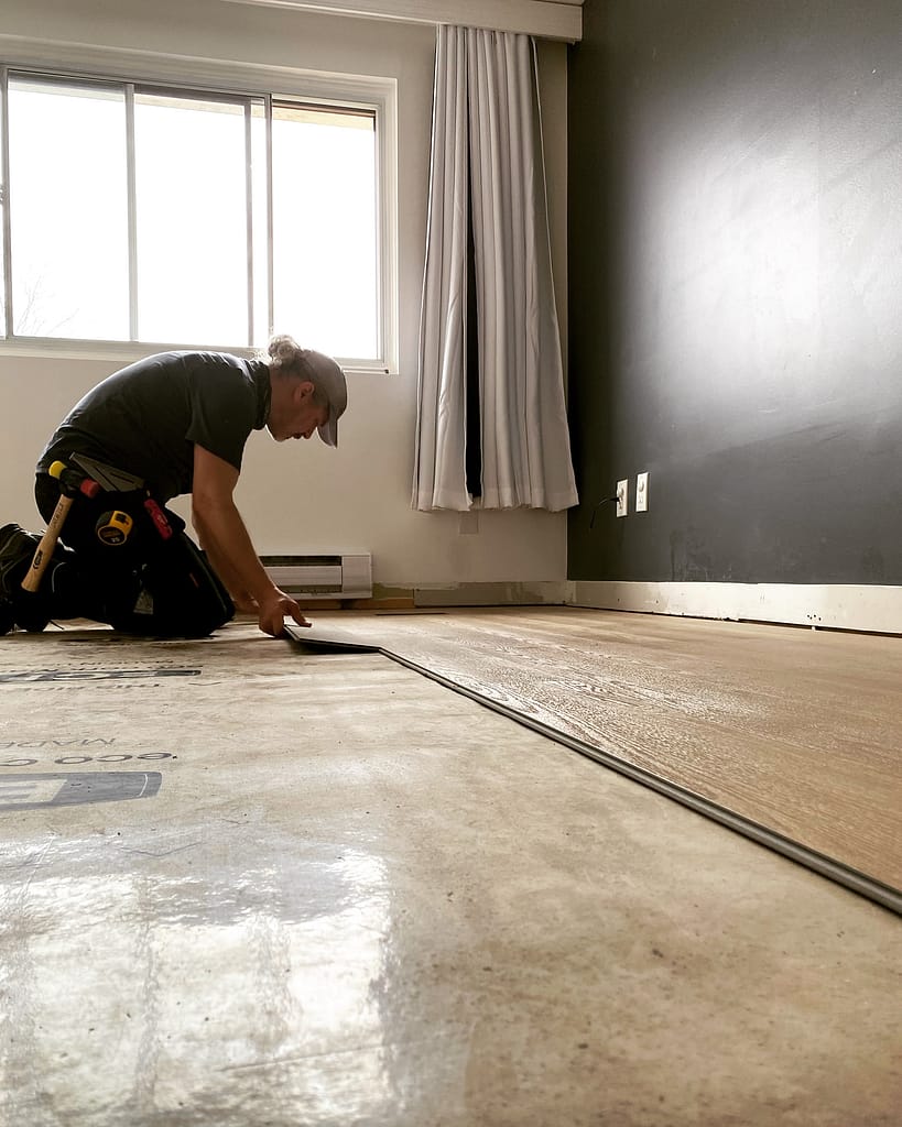 the finish carpenter is installing floor in a Milton home
