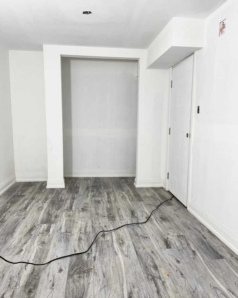 Finished vinyl flooring and baseboards in a Vaughan basement renovation