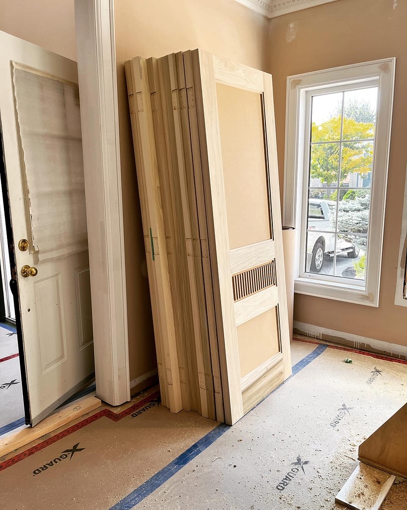 Solid interior doors prepared before painting for a Vaughan major renovation