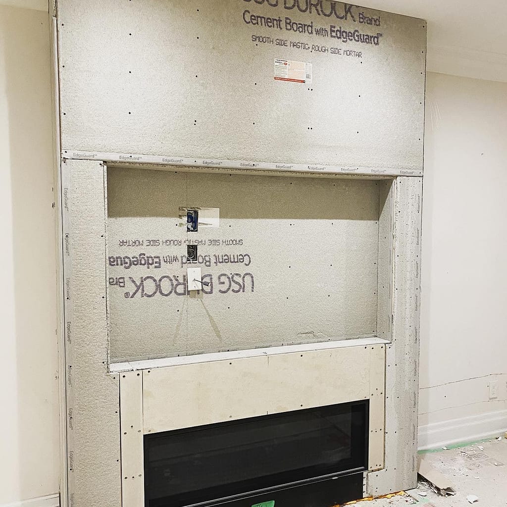 Fireplace feature wall covered with cement board and ready for tile