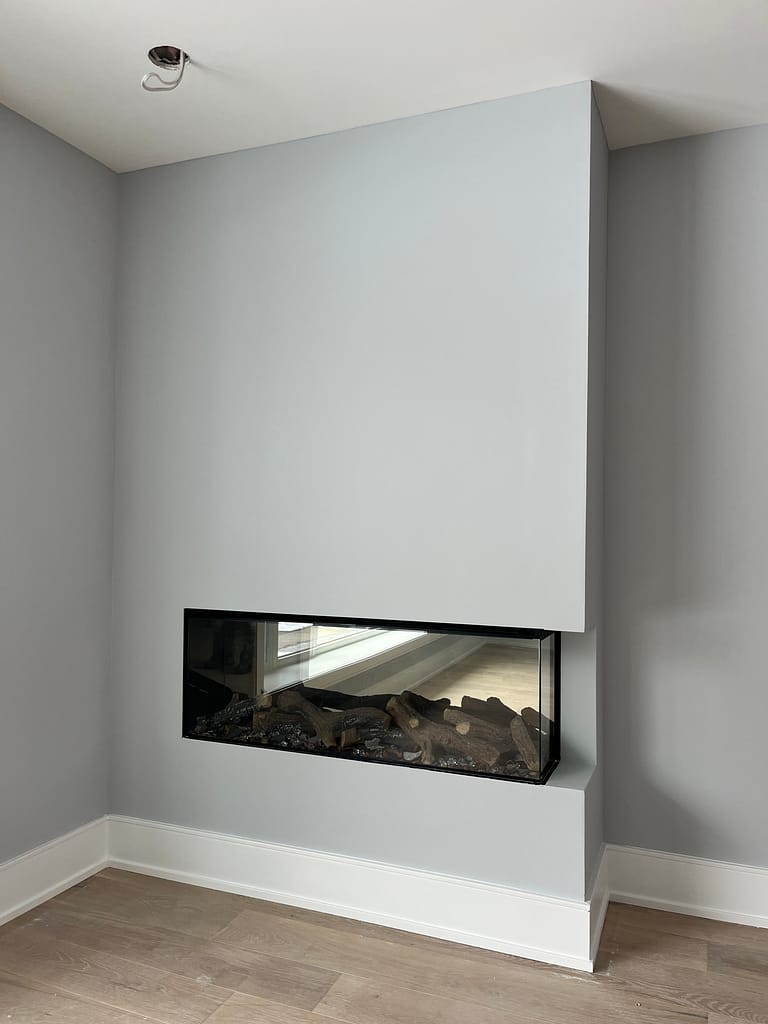 a modern fireplace framing installed by a finish carpenter at Wood Job Finish Carpentry in a Toronto bungalow renovation