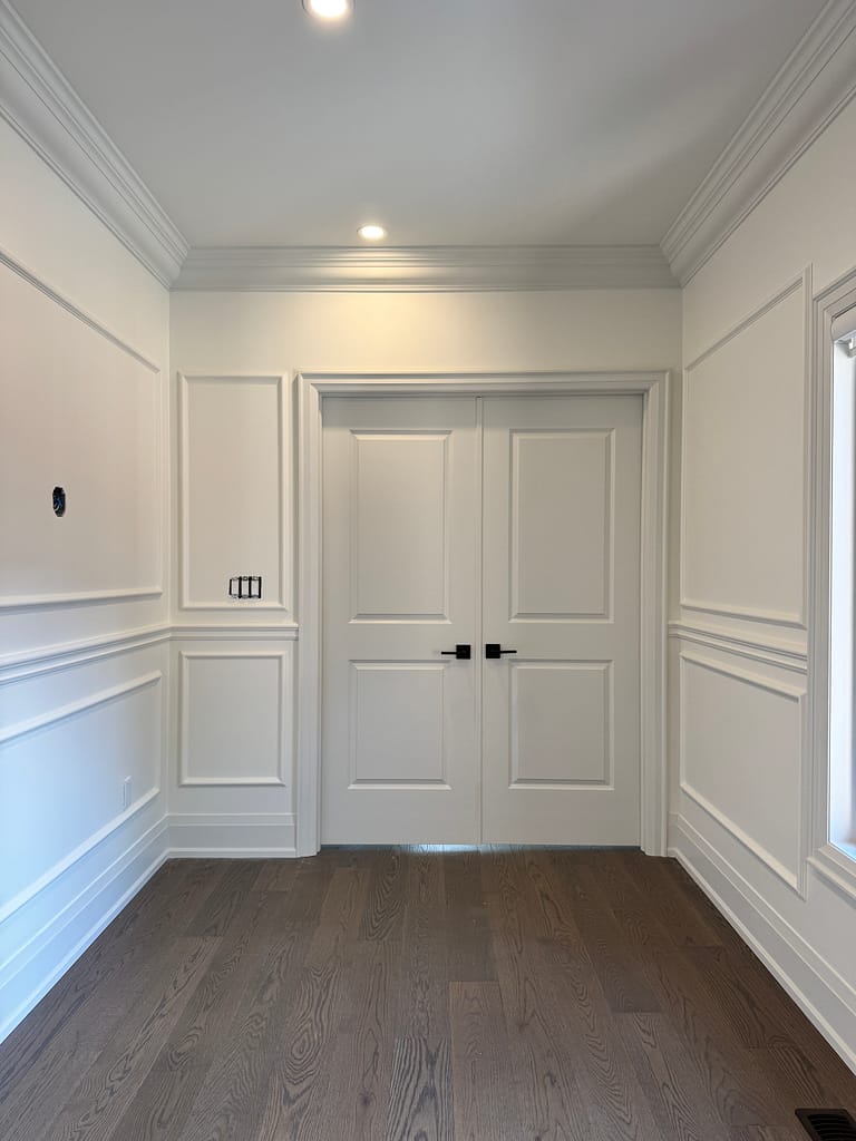 Double doors and wall panel installed by a finish carpenter in Milton