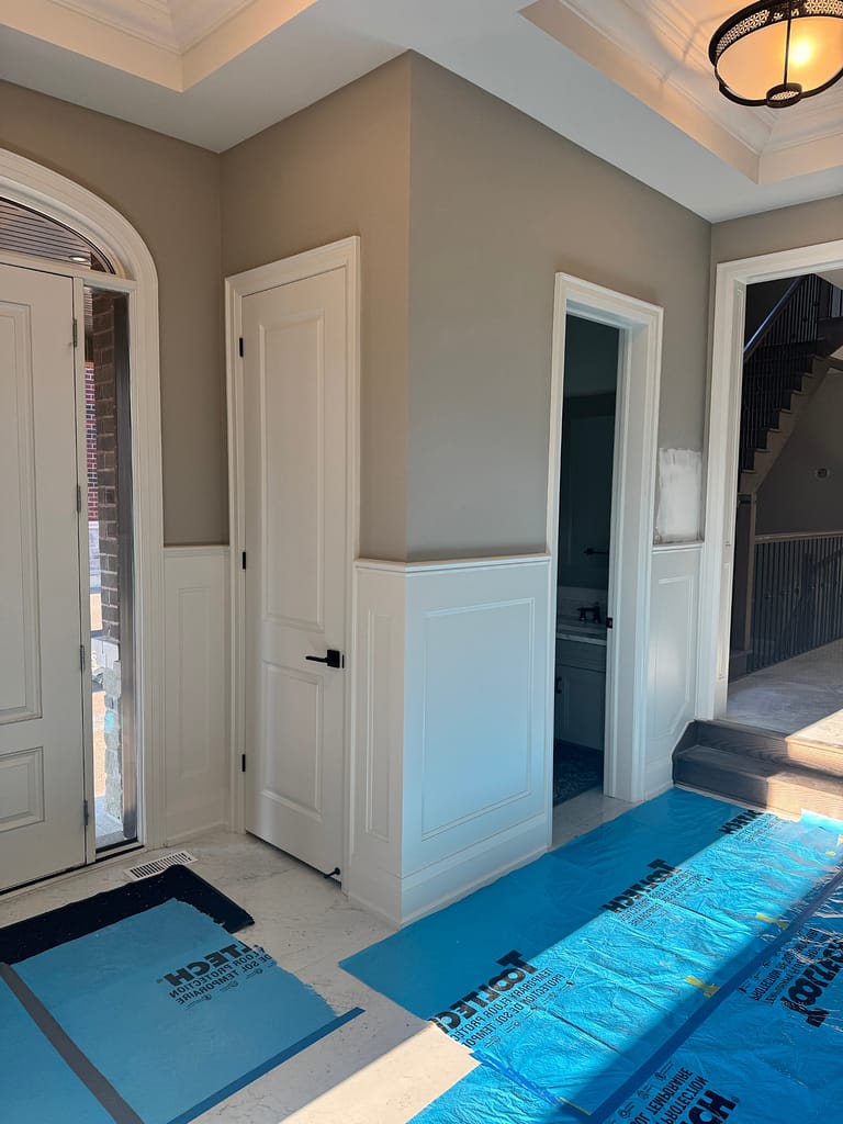 Finished foyer wall paneling in Burlington home by Wood Job Finish Carpentry