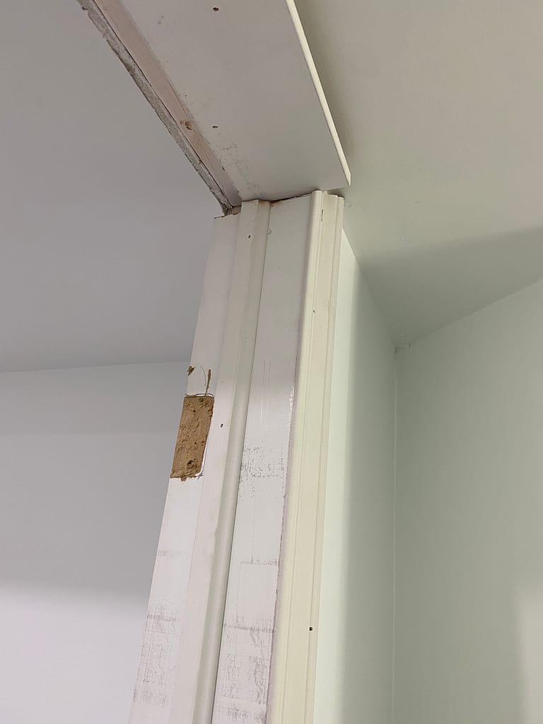 Poorly fitted door jamb before finish carpentry correction in Kitchener