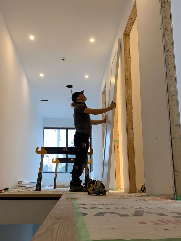 finish carpenter installs solid door in a Toronto house